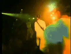 Guitarist playing on stage with green laser