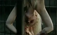 Hannibal Lecter hanging upside down in a cage