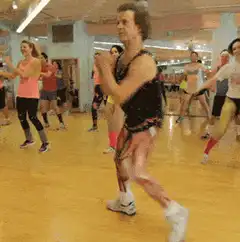 Muscular man in leotard doing aerobics