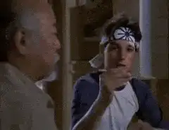 Daniel LaRusso feeding Mr. Miyagi chopsticks