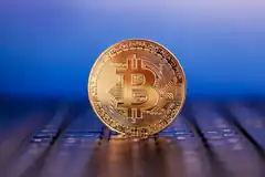 Bitcoin coin on laptop keyboard