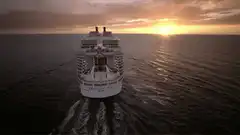 Cruise ship sailing into sunset
