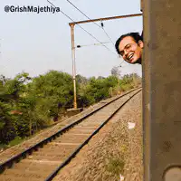 Man smiling from train window