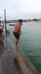 Man jumps off pier into water