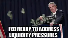 Jerome Powell shoots money from a gun