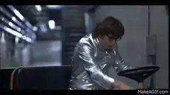 Austin Powers in silver suit driving buggy