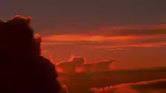 UFOs flying over a city at sunset