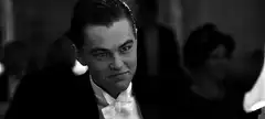 Leonardo DiCaprio toasting with a wink