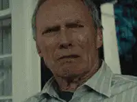 Clint Eastwood squinting and looking away