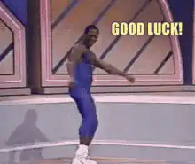 Man in blue outfit dancing with good luck text