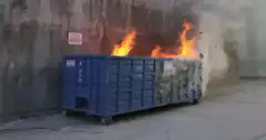 blue dumpster on fire