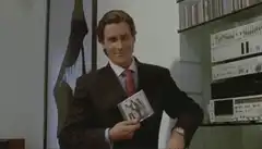 Patrick Bateman holding a CD
