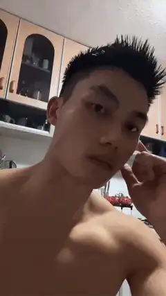 Shirtless man poses and smiles