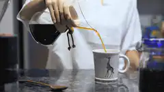 Pouring coffee into a giraffe mug