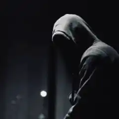 Hooded figure shoots blue laser from eyes