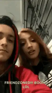 Couple makes a heart shape with their hands
