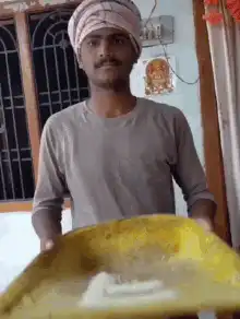 man tossing rice in yellow tray
