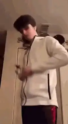 guy in white hoodie punching camera