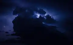 Lightning flashes in dark storm clouds
