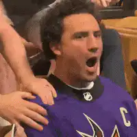 Man in purple jersey falls off couch
