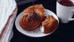 Chocolate sauce poured on churro