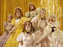 Clown dolls with pearl headdresses and ZAP text