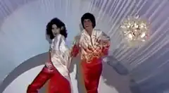 Two people dancing in red and white outfits