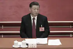 Xi Jinping seated at a table