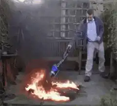 Man vacuums a fire in the garden