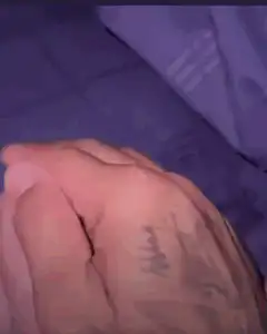 Adult hand holding baby foot with text FUG