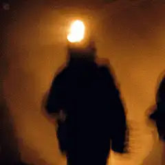 silhouette with headlamp in fog