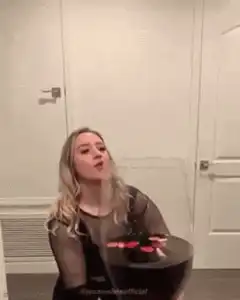 Woman drinks from giant wine glass