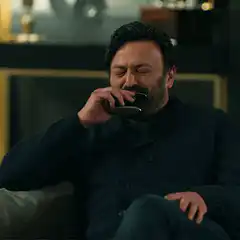 Man drinking from flask and laughing
