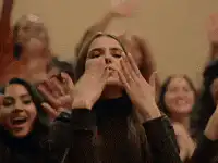 woman blowing kiss to crowd