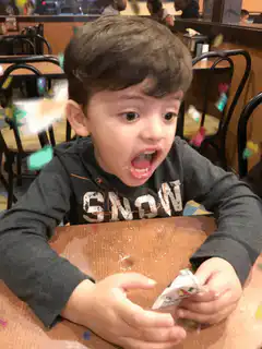 Boy eating cake with confetti