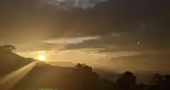 Sunset over mountains with lens flare