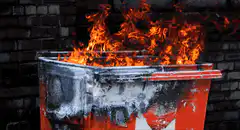 burning red trash bin