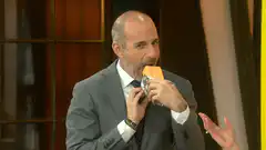 Man eating a large chip