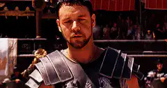 Maximus looks down then touches wheat