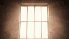 Man sitting in a dark room
