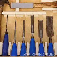 Man peeks over chisel rack