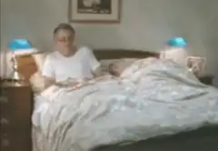 Man pulls blanket over sleeping partner