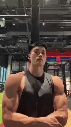 Muscular man flexing abs in gym