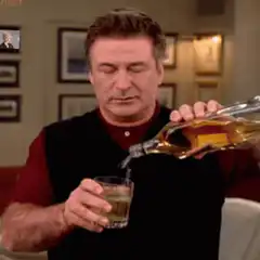 Alec Baldwin pouring a drink