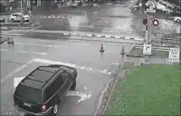 Train crossing wet street