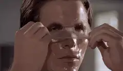 Christian Bale peels off a face mask