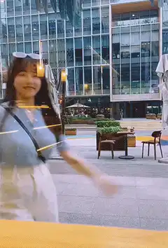 woman waving at camera through glass
