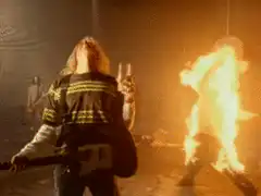 Fireman holding a beer while a person burns