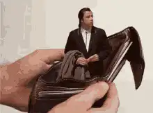 Tiny man in empty wallet