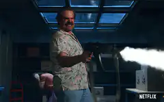 Jim Hopper sprays paint gun